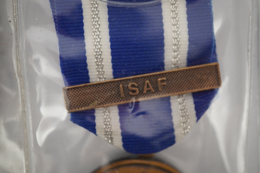 Thirteen United Nations (UN) and NATO medals, eleven UN examples with ‘ in the service of peace’ to the reverse, including a variety of ribbons for a number of different campaigns, (some duplicates), and two NATO ISAF Af